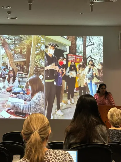 Sharing the story of the Woodstock School community hub with an international audience in Auckland. This image shows the project being used by students, illustrating the real-world impact of successful placemaking.