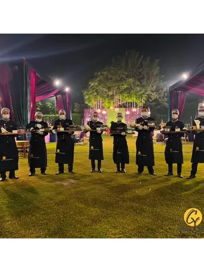My team of servers lined up at an outdoor event, holding trays of appetizers and ready to begin service.