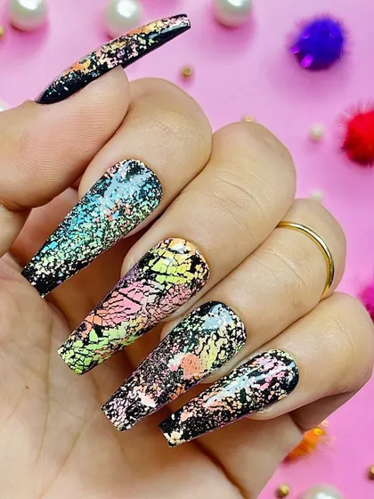 A dramatic black nail set with a colorful shattered foil effect, capturing the chaotic beauty of Holi.