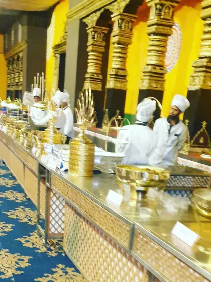 Our chefs attending to the buffet, ensuring each dish is perfectly presented and replenished. The combination of our team's service and the grand decor creates a seamless experience.