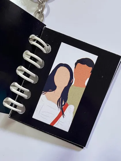 A faceless portrait inspired by a scene from a favorite show or movie, inside a keychain.