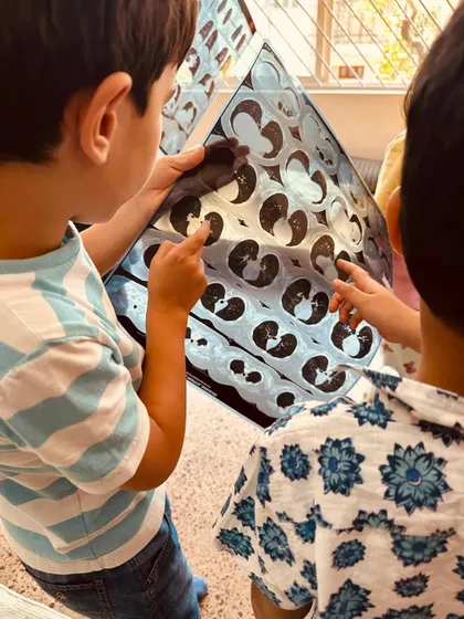 A close-up of children examining a CT scan. Their intense focus and curiosity are a testament to how engaging real-world learning can be.