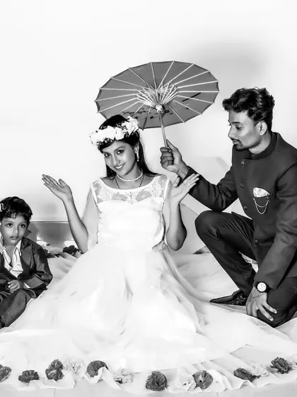 A classic black and white family maternity photo, capturing a tender and artistic moment with the whole family.