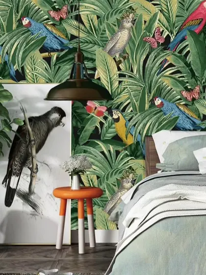 Bring the outdoors in with a vibrant, tropical-themed wallpaper. This design, featuring lush greenery and colorful parrots, is perfect for creating a lively and refreshing accent wall in a bedroom.