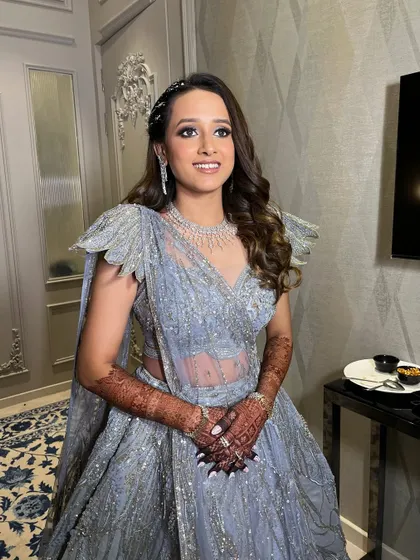 A full view of this stunning sangeet look. The glittery eyes, radiant skin, and elegant hairstyle all work together to create a truly glamorous and memorable bridal style.