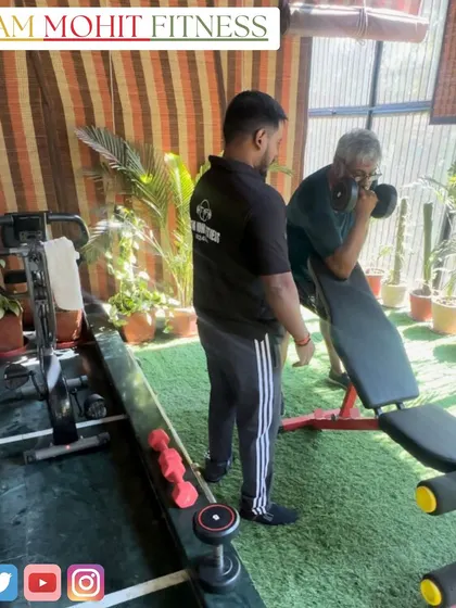 Guiding a senior client through a preacher curl on his home workout bench. Personalized attention ensures safety and proper form.