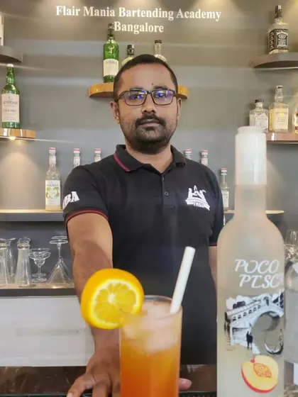 A student from our Bangalore branch showing off the cocktail he made during a practical class.