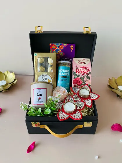 A slightly different angle of the rose-themed suitcase hamper, highlighting the artificial flowers that add a lasting decorative touch to the gift.
