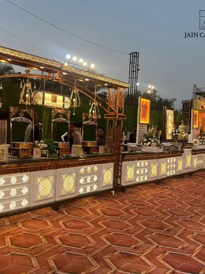 An elegant, illuminated buffet counter ready for an evening of celebration. The warm lighting and intricate details of the setup create an inviting atmosphere for guests to enjoy their meal.