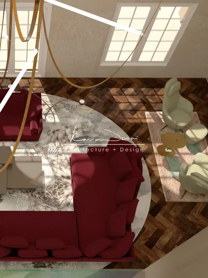 A top-down view of the statement living room, showing the arrangement of the bold red sofa on a circular rug. This perspective highlights the herringbone pattern of the wood floor and the generous scale of the space.
