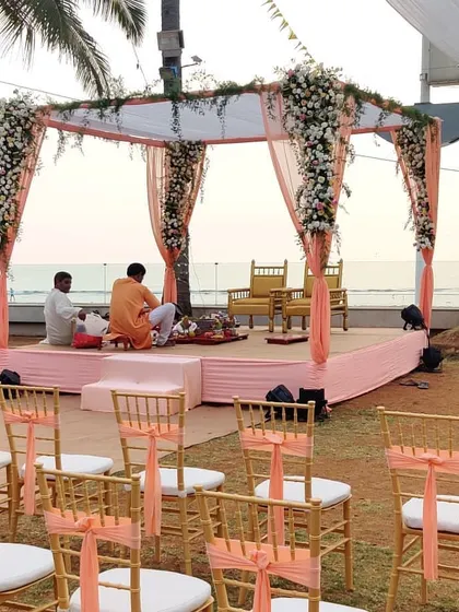Another view of the simple and elegant peach-themed mandap. This setup is perfect for couples who want the beauty of the ocean to be the main star of their wedding ceremony.