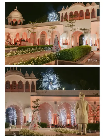 The bride's solitary walk towards the Varmala stage, set against the magnificent architecture and dazzling fireworks, creates a powerful and regal portrait.