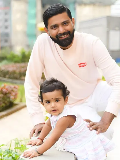 A sweet father-daughter moment captured during an outdoor family portrait session.