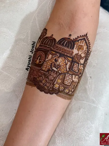 A close-up of the armband showing the groom's grand entry on a royal elephant.
