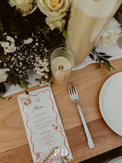 A custom menu card for the sit-down dinner, adding a personal and thoughtful touch to the tablescape.