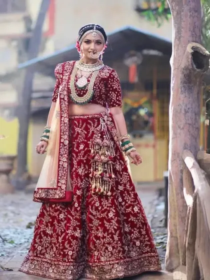 This stunning red velvet bridal lehenga is perfect for a winter wedding. The rich fabric and detailed embroidery create a look of pure opulence and warmth.