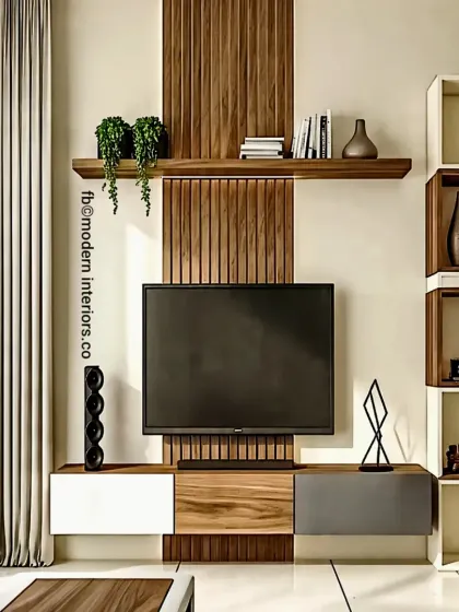 This TV unit design features a striking vertical wood panel that contrasts with the white and grey console. The asymmetrical layout includes a floating shelf and a unique block-style shelving unit on the side for displaying art and books.