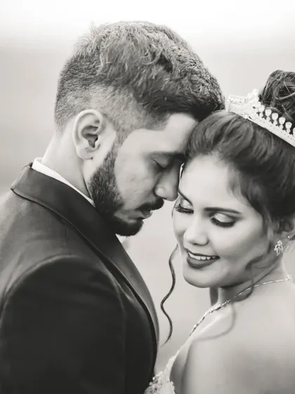 An intimate black and white close-up of the couple. The monochrome tones highlight their expressions and the emotional connection between them.