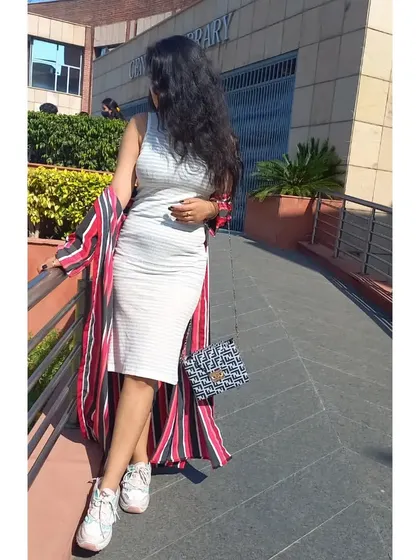 A comfortable and stylish layering look for college. I wore a longline red and black striped shrug over a simple white bodycon dress, finished with chunky white sneakers and a patterned bag.