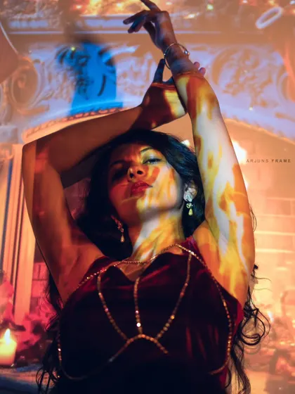Playing with light and shadow in a conceptual shoot. Using a projector, we created this fiery, artistic effect to tell a story without words, highlighting my ability to model for creative projects.
