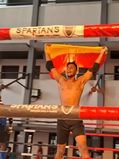 Flying the Karnataka flag high in Kerala. Our fighter celebrates his gold medal win, representing our state with pride and passion.