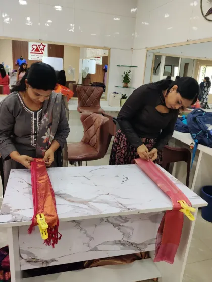 Here you can see my students deeply focused during a hands-on practice session. They are learning to create perfect pleats using my table-top method.