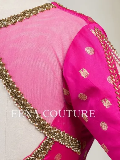 A closer look at the craftsmanship of this pink pure silk blouse. It features intricate handwork with bead detailing on the neckline and delicate net sleeves with linear embroidery for a touch of grace.
