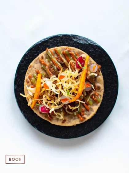 An overhead shot of the vegetarian taco, showcasing the vibrant colors and layers of ingredients. I design my dishes to be as beautiful as they are delicious.