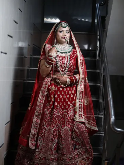Our beautiful live bride, looking absolutely regal in her red velvet lehenga. The makeup is designed to be bold and long-lasting, perfect for a grand wedding celebration.