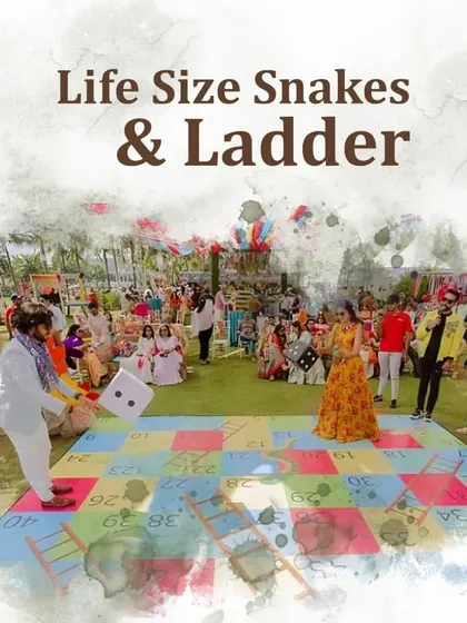 A life-size Snakes & Ladders game set up on the lawn, providing a fun and nostalgic activity for guests of all ages.