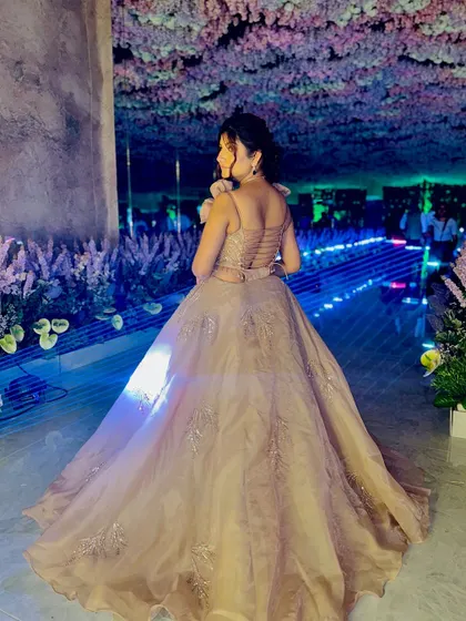 A back view of the gown, highlighting the delicate strap details and the way the skirt trails beautifully. Every angle of this dress is designed to impress.