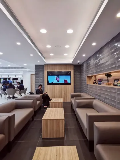 The customer lounge, designed for comfort during wait times. It features plush sofas, soft lighting, and access to reading materials and entertainment, ensuring a premium service experience from start to finish.