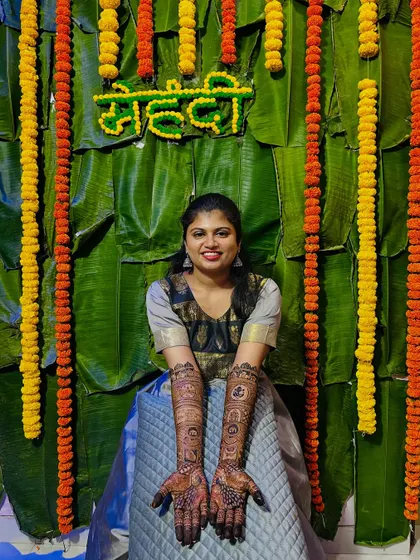 The bride proudly displaying her full bridal mehendi. The intricate patterns are a testament to the hours of artistry.