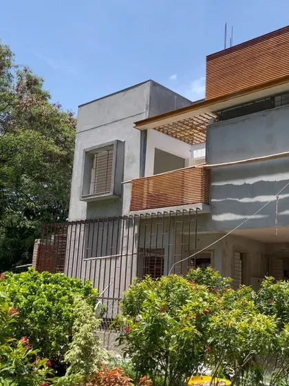 A corner view of the house, showing the relationship between the solid volumes and the open balconies.