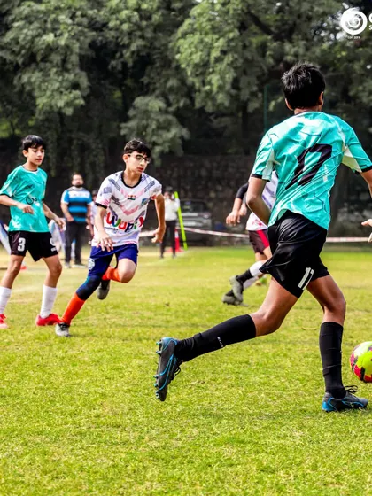 A player looks to get past a defender in a fast-paced youth game.
