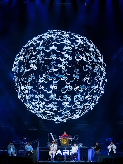 A stunning visual from The Wonderment Tour, where a sphere of light composed of Arabic calligraphy for "love" floats above the stage, showcasing our use of advanced, culturally rich anamorphic visuals.