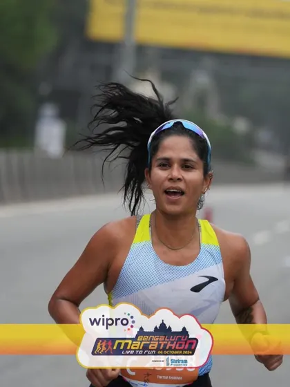 A close-up shot showing the effort and focus required in the later stages of a half marathon. This is where your training really shows. I prepare you to be strong all the way to the finish.