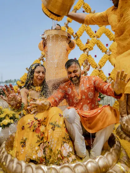The pure, unadulterated joy of a Haldi ceremony. We love capturing the energy when families come together for this vibrant ritual, like this unforgettable moment from Sparsha and Karthik's lakeside celebration.