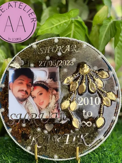 A complete wedding story in one piece. This circular resin frame preserves a couple's varmala, kaleera, and sehera, all surrounding their wedding photo. It's a beautiful way to keep all your precious items together.