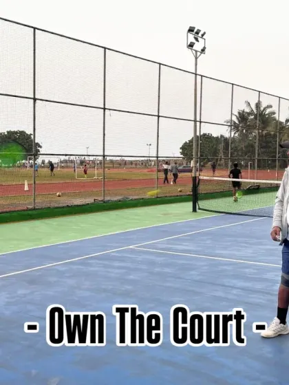 We teach our players to own the court. A coach feeds balls to a player, drilling him on returns and court coverage, building the stamina and confidence needed for competitive play.