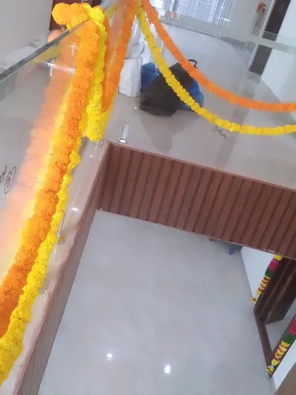 Simple marigold garlands hung along an indoor railing. This is an easy and effective way to add a festive touch.