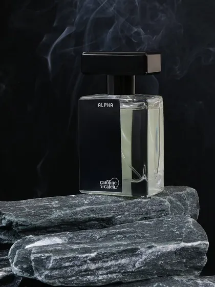 For the 'Alpha' perfume, I used a dark background, natural stones, and a hint of smoke. This creates a powerful, elemental, and distinctly masculine image.
