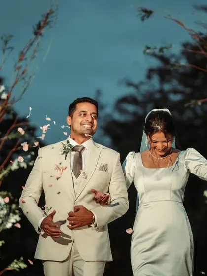 A joyful exit as the newly married couple walks down the aisle, showered with petals by their guests.