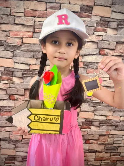 This student personalized her pencil box and is holding up a custom keychain she made. Our workshops encourage kids to add their own names and special touches to their crafts.