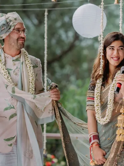 A couple shares a lighthearted moment during their wedding ceremony, showcasing their easy chemistry.