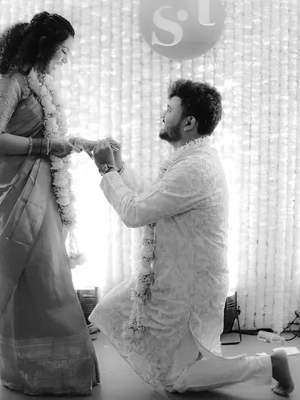 A beautiful black and white shot of a proposal during an engagement ceremony, highlighting the emotion of the moment.