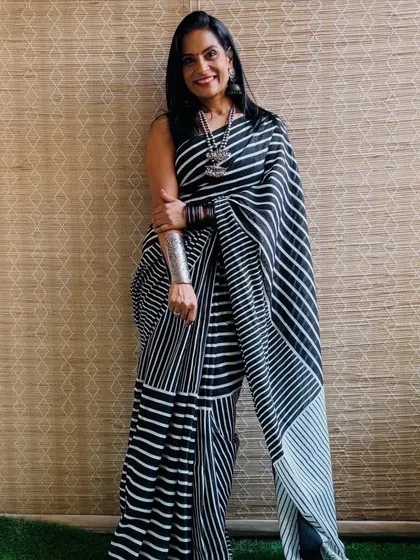 A classic black and white striped cotton mulmul saree. This is a versatile piece that can be styled for a modern workwear look or a chic casual outing.