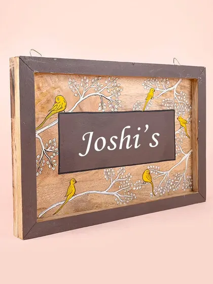 Another angle of the "Joshi's" bird-themed nameplate, highlighting the natural wood grain and the hand-painted details.