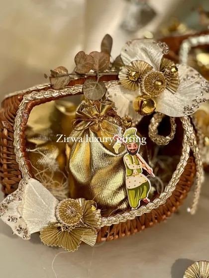 This close-up shows the details of my Lohri baskets. The small dancing bhangra man cutout adds a playful and authentic touch to the golden-themed arrangement.