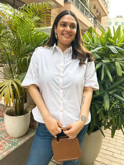 The classic summer uniform: a white shirt and blue jeans. This shirt from Stitch Stories has the cutest floral detailing on the shoulders, a small touch that elevates a timeless piece.